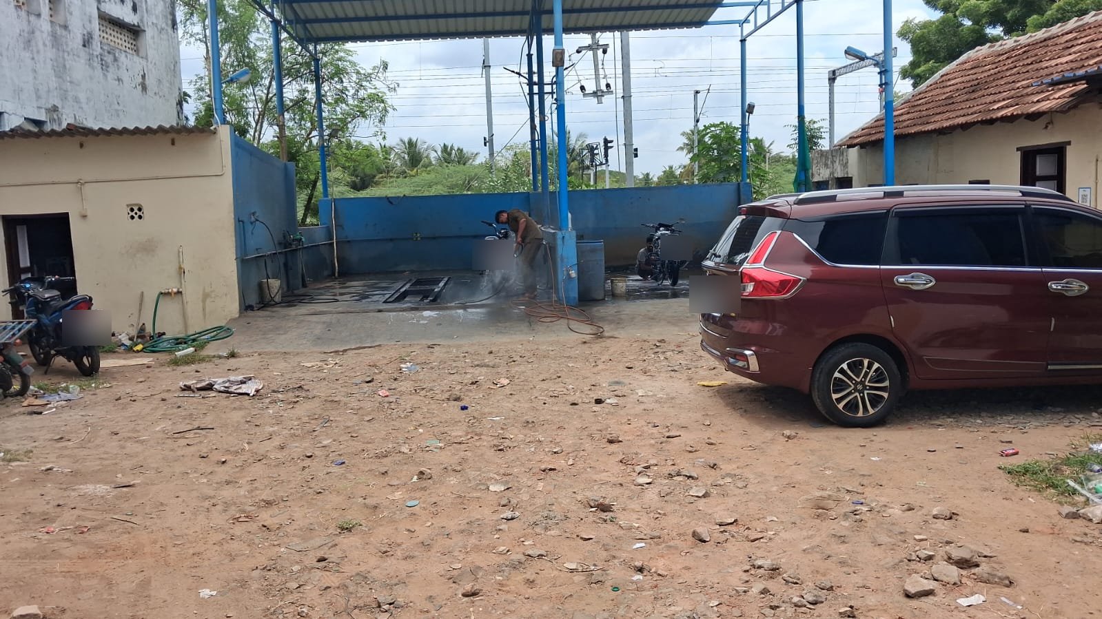 Vehicle water wash in progress at ASM Water Wash & Car Care, part of the ASM Group (registration plates obscured for privacy)